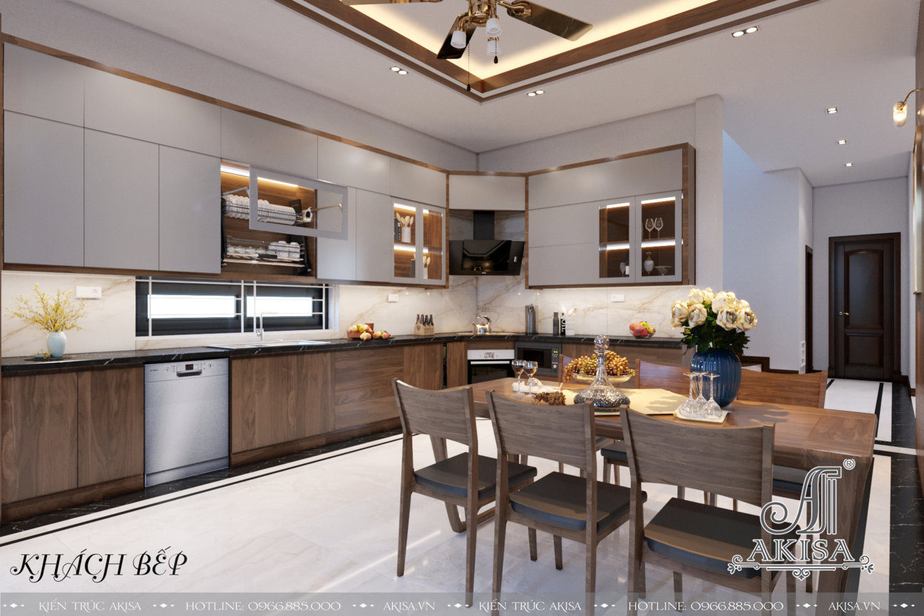Vẻ đẹp nhẹ nhàng, tinh tế của phòng bếp trắng sang trọng kết hợp với các đồ nội thất bằng gỗ, đèn âm trần thiết kế đơn giản