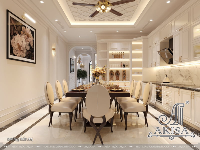 Phòng bếp ăn sử dụng gam màu trắng ngà kết hợp ánh đèn vàng ấm cùng cùng các đồ nội thất đơn giản mà thanh lịch.