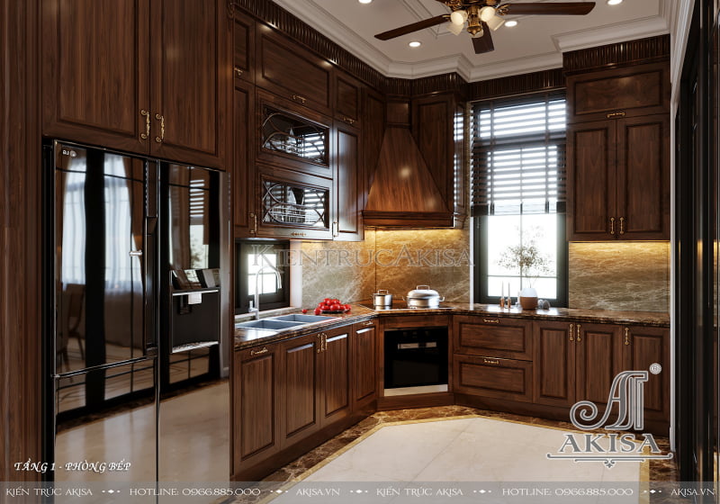 Không gian phòng bếp gọn gàng tiện nghi với thiết kế dạng chữ L cùng tủ bếp chất liệu gỗ gõ tự nhiên cao cấp