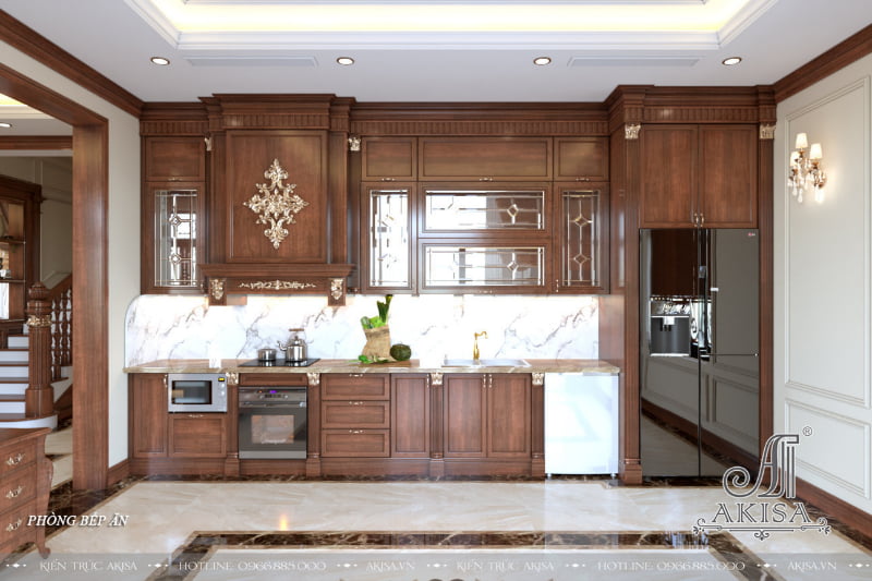 Không gian căn bếp vô cùng tiện nghi với điểm nhấn là hệ tủ bếp được thiết kế dạng chữ I 2 tầng cao sát trần, tận dụng tối đa diện tích bếp, được chia thành nhiều ngăn, kệ, kích thước phù hợp, được bố trí gọn gàng và khoa học.